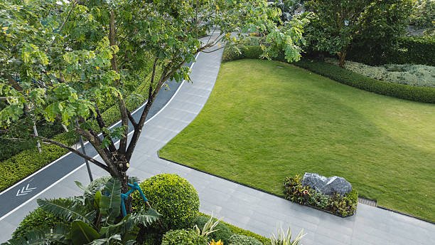 Aerial view of urban modern residential area with walking path and sustainable planting design.